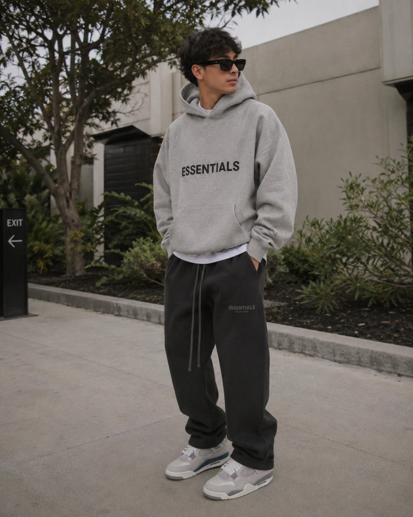 Influencer-style outfit wearing grey Essentials hoodie outdoors